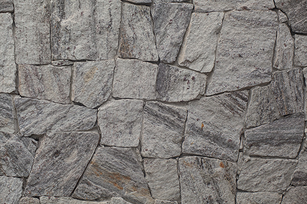 textured stone wall featuring gray and brown shades suitable for three-dimensional design or construction projects