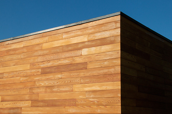 wooden exterior wall corner under clear blue sky showcasing natural texture and design elements related to 7 different styles