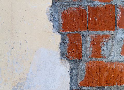 exposed brick and plaster wall with a mix of textures emphasizing two distinct surfaces