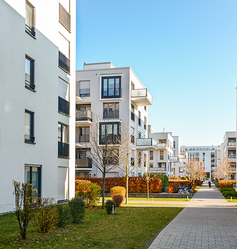 modern residential buildings in urban area with landscaped pathway and greenery showcasing contemporary architecture 4 apartments for residents